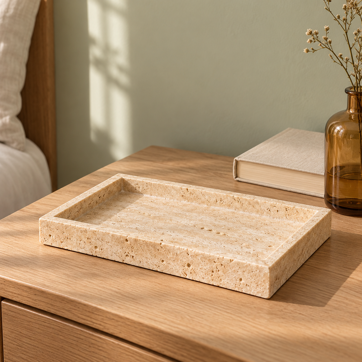 Golden Travertine Tray on a bedside table with a book and vase