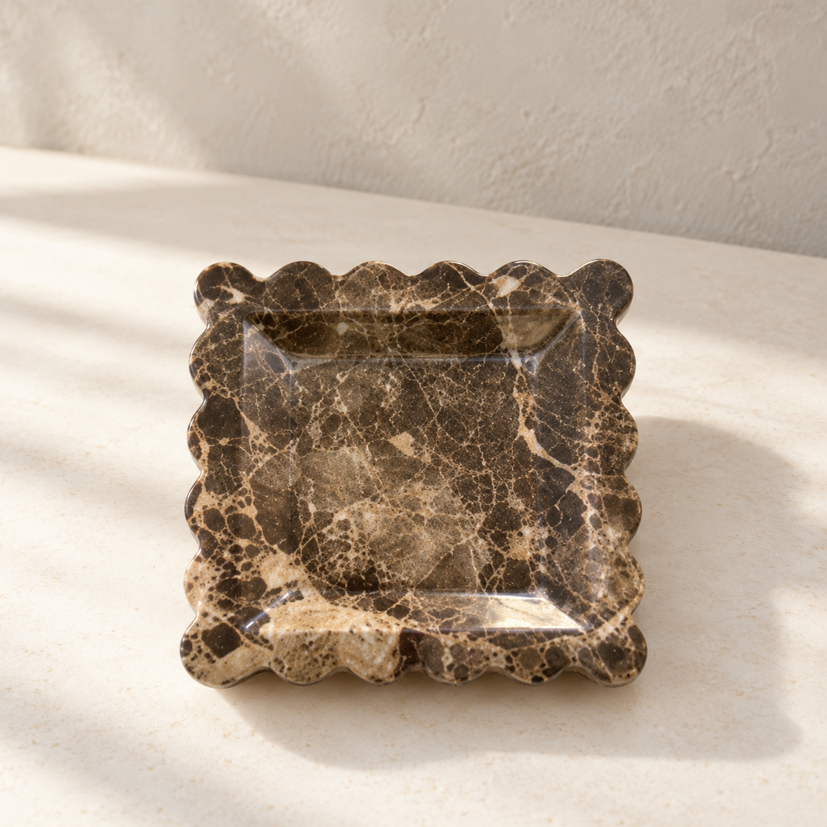 Scalloped Marble Dish on a cream stone surface in soft daylight