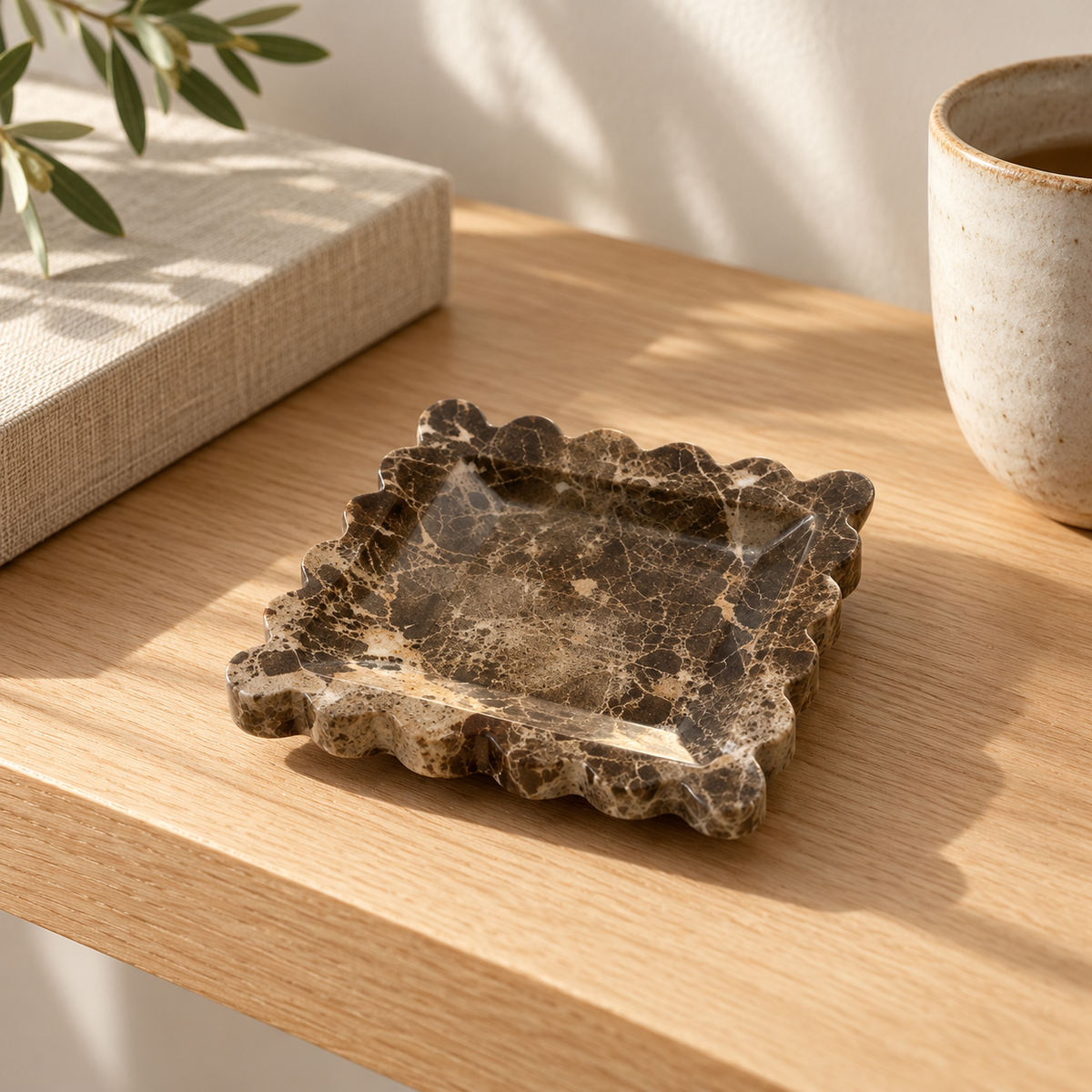 Scalloped Marble Dish on an oak shelf beside a stoneware vase