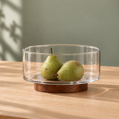 Glass Fruit Bowl with Wood Base on a dining table in warm natural light