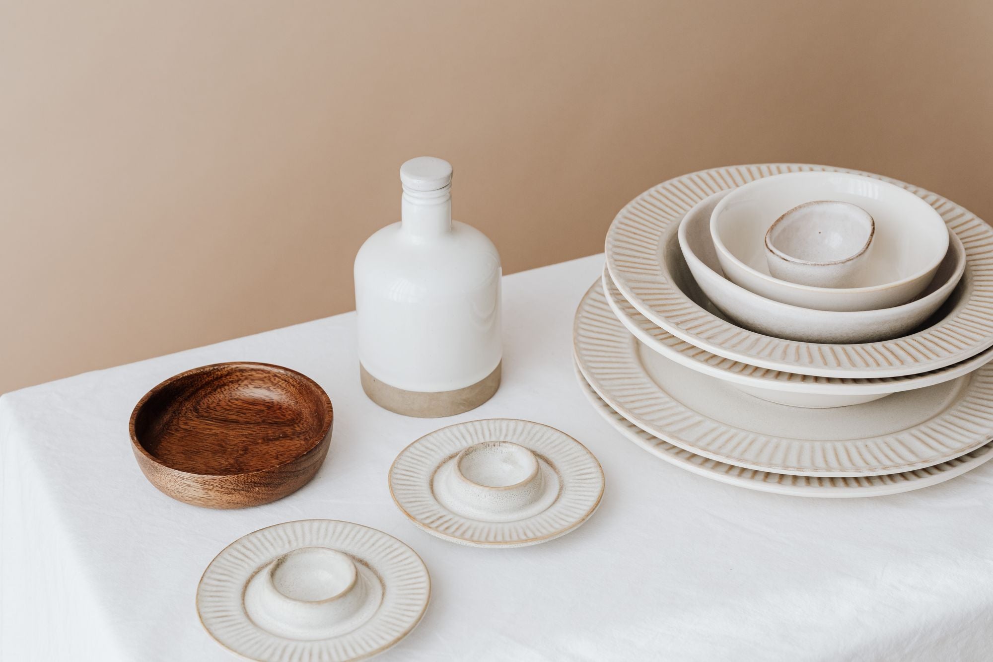 A styled table with neutral ceramic dinnerware