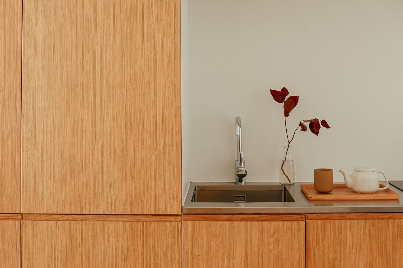 A calm kitchen counter with warm wood and a simple tea setting